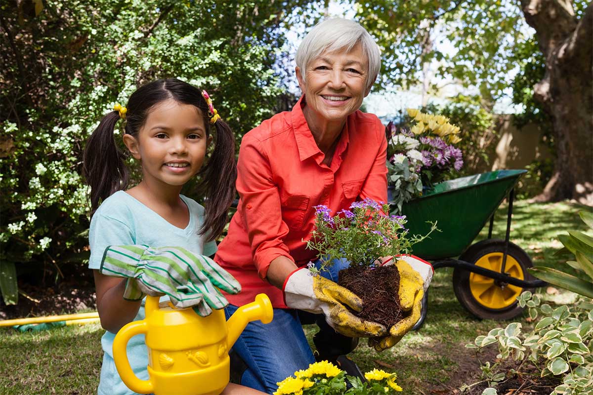 Senior gardening with girl